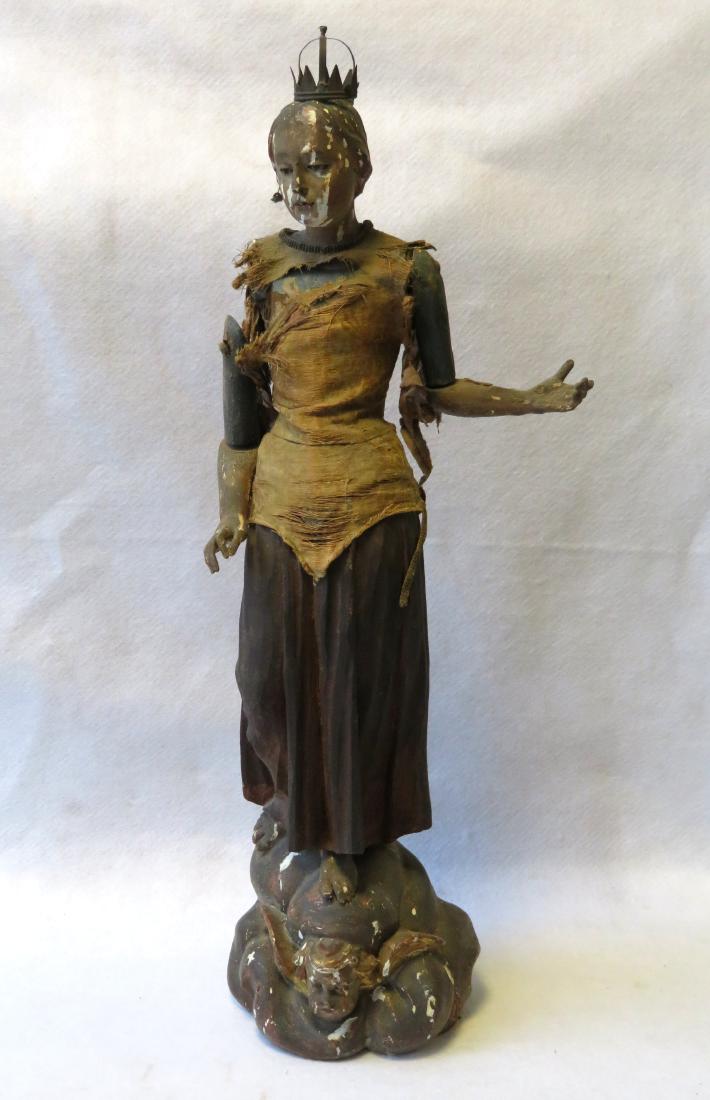 Rare hand carved sculpture of a woman , probably a: Rare hand carved sculpture of a woman , probably a saint, wearing a tin crown, all original including the gold and blue paint - The figure is standing on a rock ledge above a carved cherub - the inter
