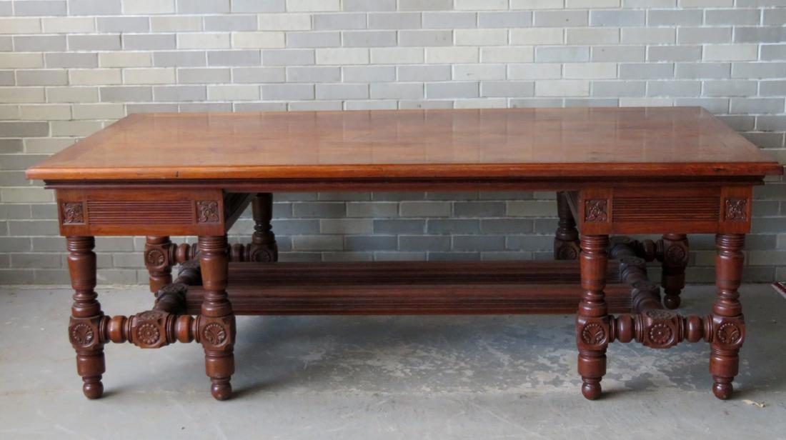 Large Victorian black walnut library table or partner's: Large Victorian black walnut library table or partner's desk, with double pedestals comprised of 4 turned legs, carved medallions, cross stretchers and ball feet. Circa 1870-80. Very good condition. N