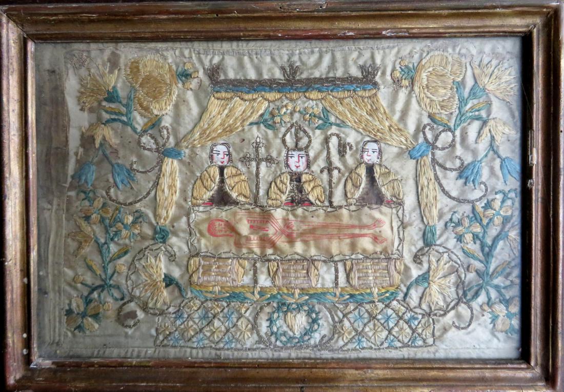 A silk embroidery depicting a bishop and 2 priests: A silk embroidery depicting a bishop and 2 priests holding the Schroud of Turin - watercolor highlights - floral border and the sacred heart beneath the Schroud - sight size 13 3/4" x 9" - stain on le