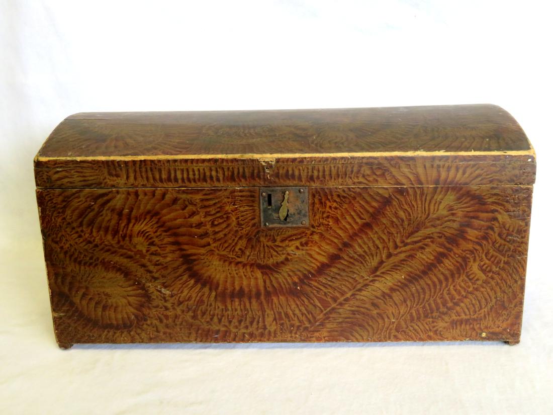 A clean colorful grain painted dome top storage box: A clean colorful grain painted dome top storage box with original lock, mid 19th century. Missing hasp, slight wear around the top front edge of lid, tight hairline on lid, otherwise very good conditi