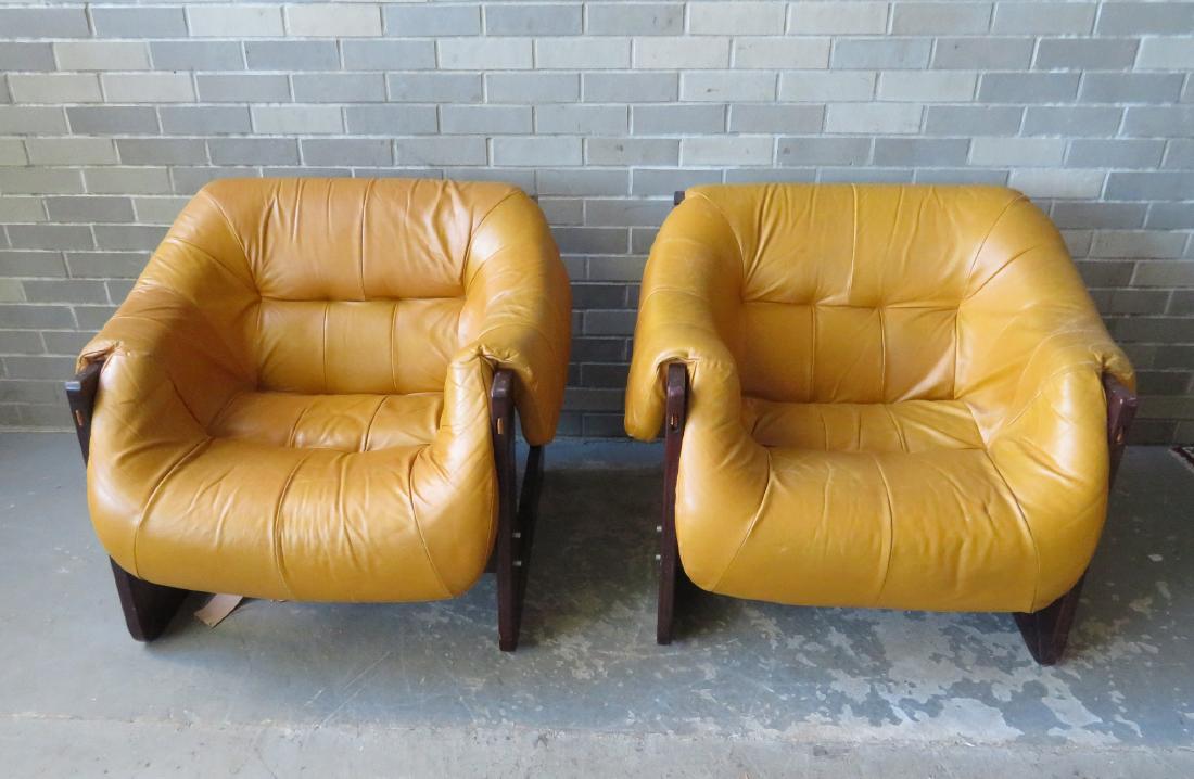 Percival Lafer design chairs: 2 mid-century style: Percival Lafer design chairs: 2 mid-century style Brazilian leather lounge chairs with rosewood frames - remnants of original paper label on underside of chairs. The leather straps that hold the seats