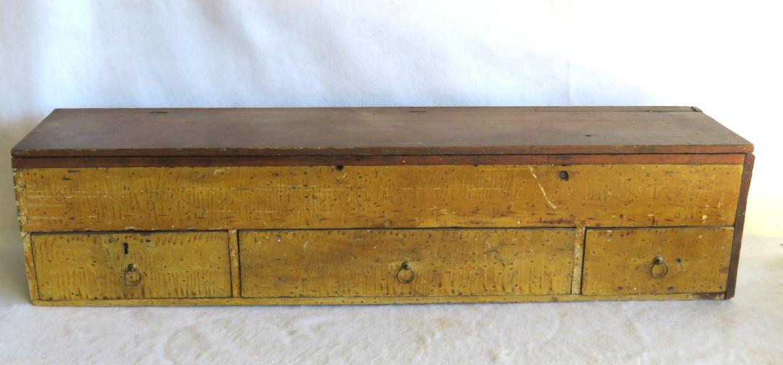 Grain painted storage box with hinged lid over: Grain painted storage box with hinged lid over sectional interior, over 3 drawers, 19th century. Probably a removable box from a carpenter's tool chest. 33 3/4"W x 8"D x 7 3/4"H. Provenance: From a pr