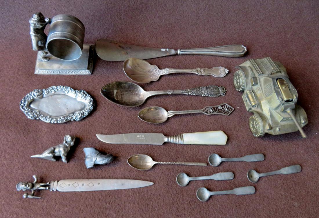 Grouping of decorative objects including a gold plated: Grouping of decorative objects including a gold plated tank form cigarette lighter - mechanics work fine but no flame, a shoe horn with sterling handle, a small sterling pin tray, a sterling letter op