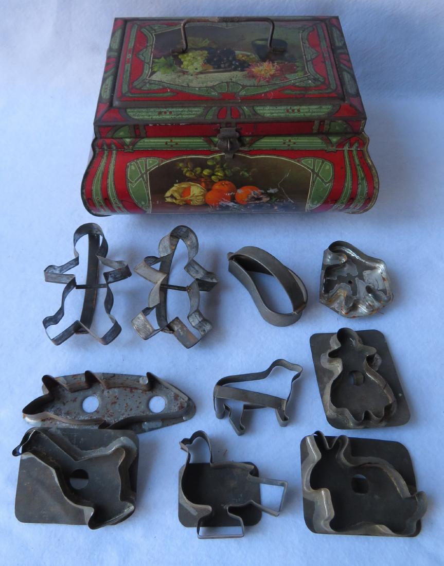 Colorful lithograph cookie tin decorated with fruit,: Colorful lithograph cookie tin decorated with fruit, together with 10 figural cookie cutters including bird, fish, duck, rabbit, lady ginger bread man, heart, etc. The cutters all appear to be 19th ce