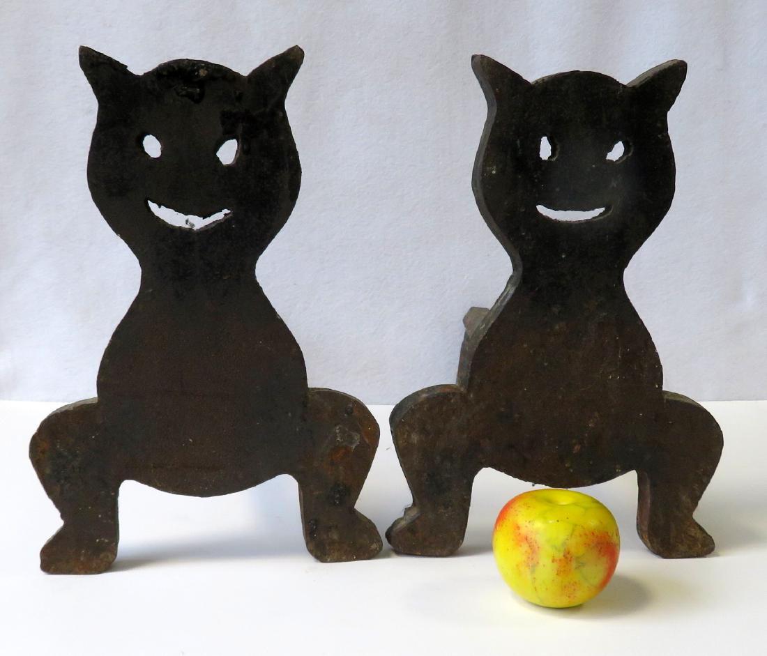 Pair of hand made cast iron Cheshire cat form andirons,: Pair of hand made cast iron Cheshire cat form andirons, early 20th century, very good condition. 14"H x 17 1/2"D x 9 1/4"W.