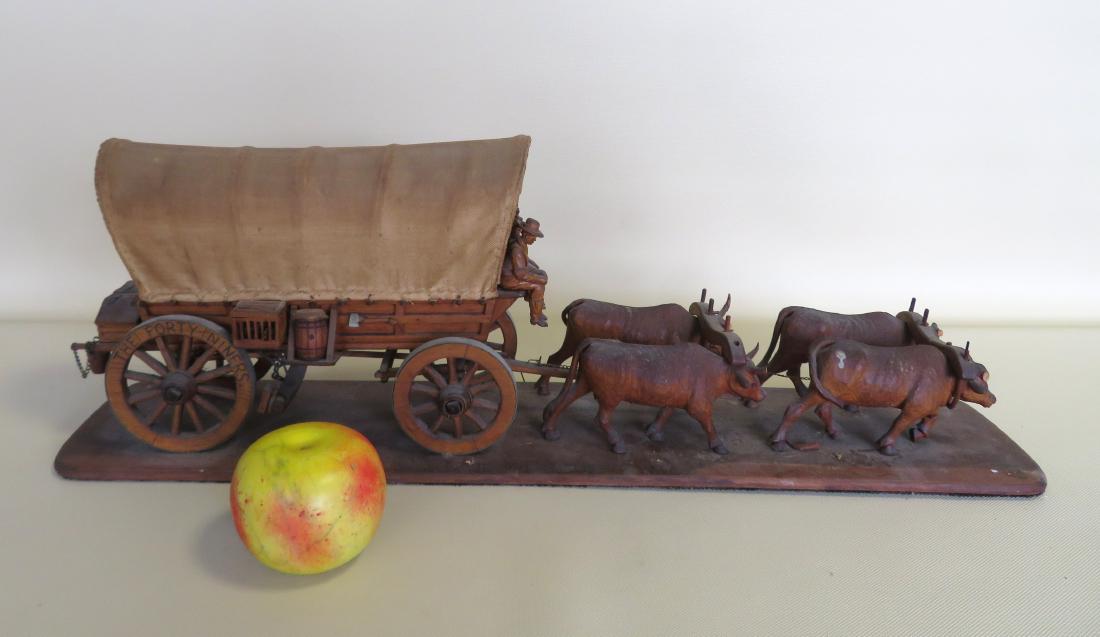 Hand made wooden model of a covered wagon pulled by: Hand made wooden model of a covered wagon pulled by oxen, late 19th century - one rear wheel marked "The Forty Niners". The wagon, with realistic construction including wood wagon wheels with spokes, 