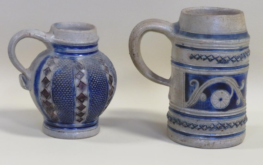 Two Westerwald mugs, the smaller decorated with: Two Westerwald mugs, the smaller decorated with diamonds and a fish scale like design in background - 5"H (2 tight hairlines across handle, otherwise very good condition); and the other decorated with