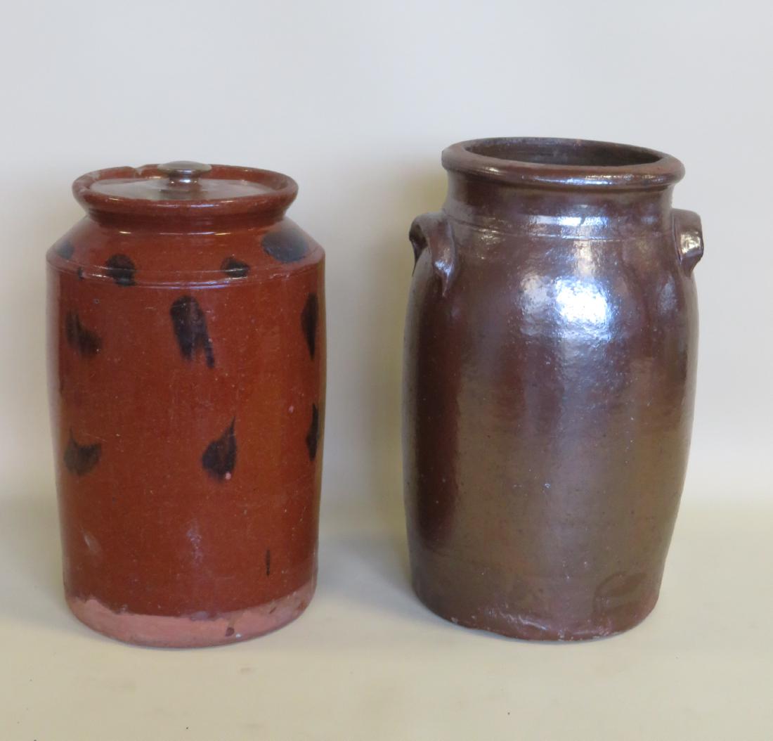 Two redware pantry jars: 1) With lid and manganese: Two redware pantry jars: 1) With lid and manganese decorations, 13 1/2" - repair to collar and chip on collar, minor surface scratches, lid 19th century but not original, otherwise good good condition