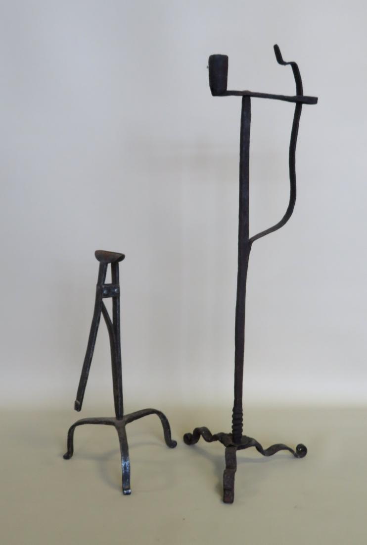 Two early hand forged iron lighting devices including a: Two early hand forged iron lighting devices including a rush light and a combination rush and candle light. Both late 18th to early 19th century. Very good condition. 23 1/2"H & 12 3/4"H. Provenance: 
