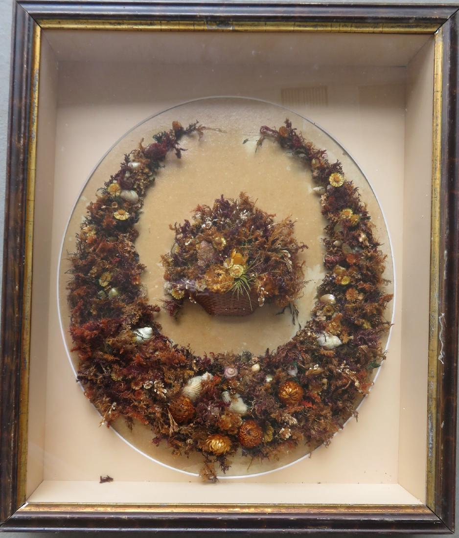 A Victorian framed wreath created with miniature dried: A Victorian framed wreath created with miniature dried flora and sea shells - the wreath surrounds a miniature woven splint basket also holding flora. Original shadow box frame with gold inset. Very g