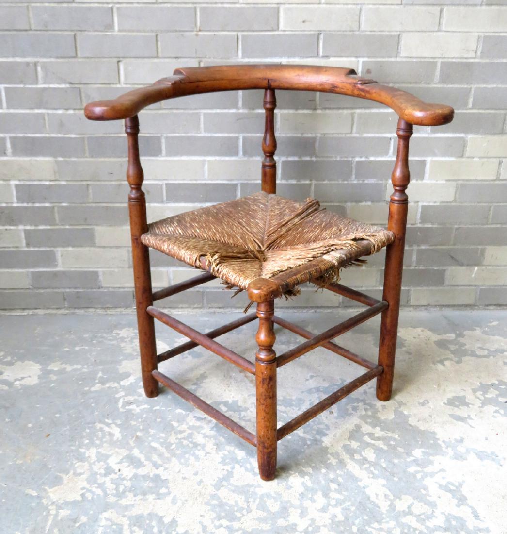 Queen Anne maple corner chair with shaped arms and with: Queen Anne maple corner chair with shaped arms and with remnants of a rush seat, late 18th century. Two small wood splits in the raised portion of the arm curved back rail, else good condition. 28 1/4