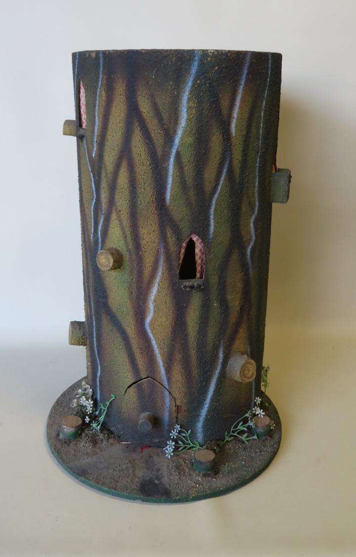 A tree house doll display in the form of a tree trunk,: A tree house doll display in the form of a tree trunk, reportedly for the storage and display of small Steiff animals, possibly a country store display. It has a back door for easy storing. 26 1/2"H x