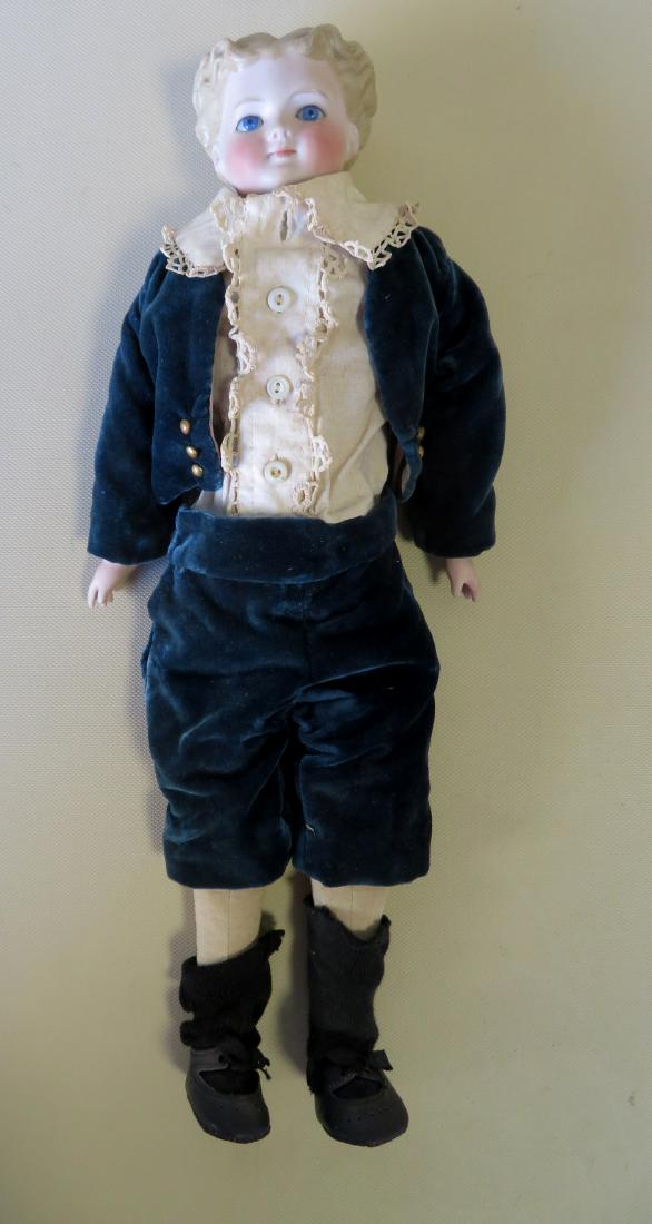 Parian ware shoulder head doll with cloth body, molded: Parian ware shoulder head doll with cloth body, molded hair and fixed blue glass eyes, late 19th to early 20th century. 16.5"H. A replaced custom made costume. Very good condition. Marking on the back