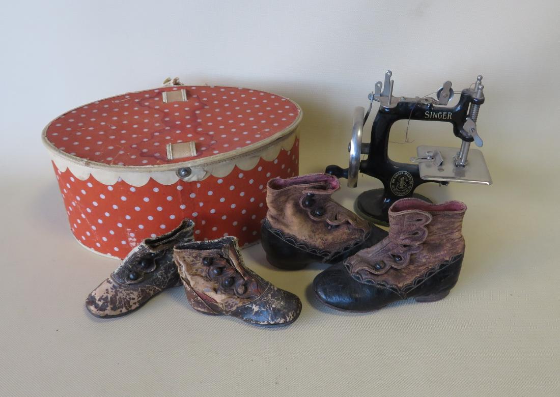 Grouping of child related collectibles including a cast: Grouping of child related collectibles including a cast iron working model of a Singer sewing machine in original paint, early 20th century - very good condition, and 2 pairs of child's button top sho