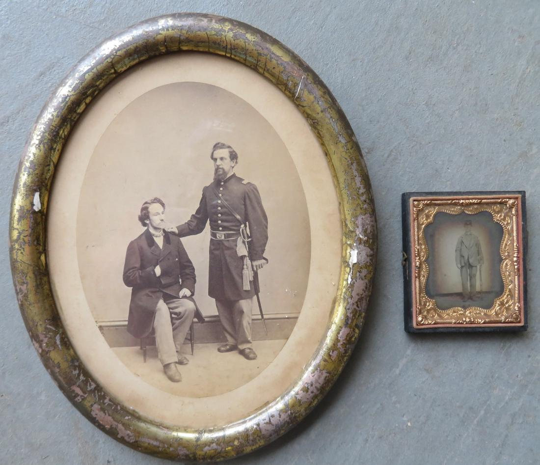 Two Civil War era portrait photos of unidentified: Two Civil War era portrait photos of unidentified sitters: Oval portrait of an officer wearing sword next to seated man - very good condition - original lemon gold frame with losses to paint - Frame s