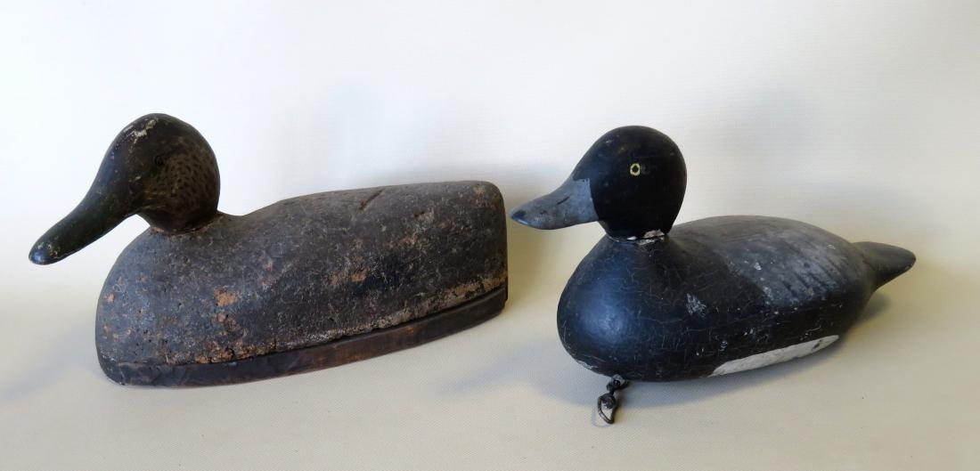 Two duck decoys including Black Duck in cork with hand: Two duck decoys including Black Duck in cork with hand painted wooden head (shot marks on neck), and a Mason style that appears to be in second paint. Both good condition.