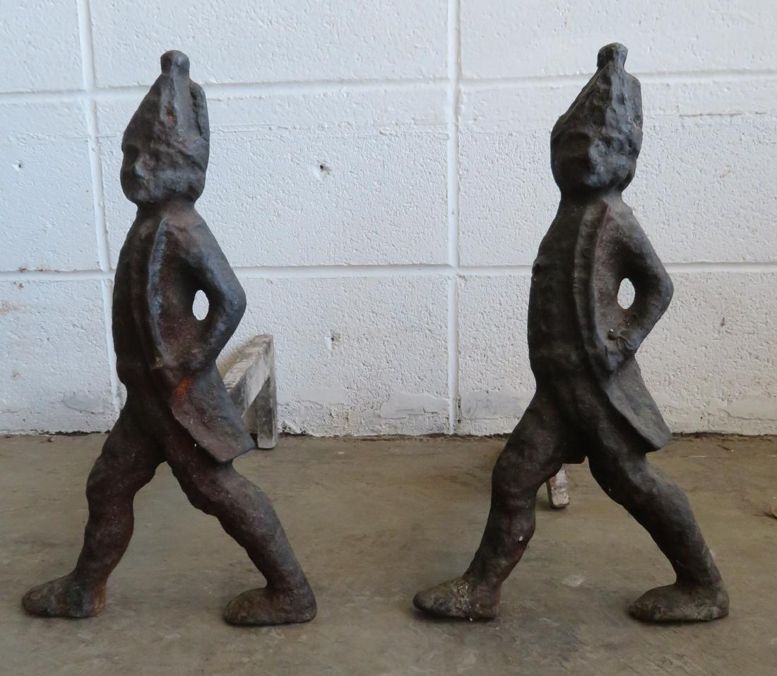 Pair of cast iron Hessian soldier andirons, this being: Pair of cast iron Hessian soldier andirons, 19th century. Dovetailed joints for firedogs - one firedog is broken and needs to be welded, else good condition. 17"H.