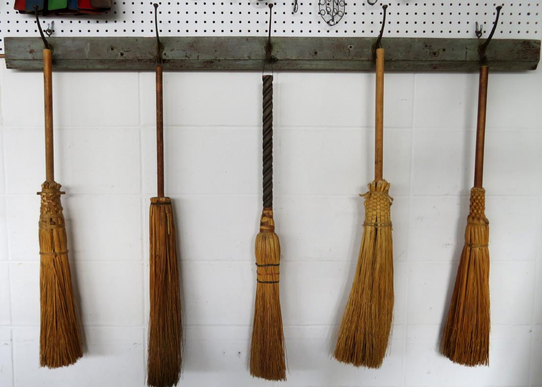 An artistic display of 5 vintage brooms, all hand made,: An artistic display of 5 vintage brooms, all hand made, late 19th to early 20th century - all creatively mounted on a 19th century coat rack in original green paint. The rack is 5'L x 3 1/2"H and each