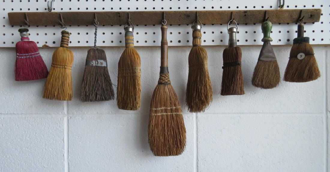 An artistic display of 9 vintage hand made whisk: An artistic display of 9 vintage hand made whisk brooms, late 19th to early 20th century. All creatively mounted on a 19th century tobacco drying rack. The rack is 3'L and the brooms range in size fro