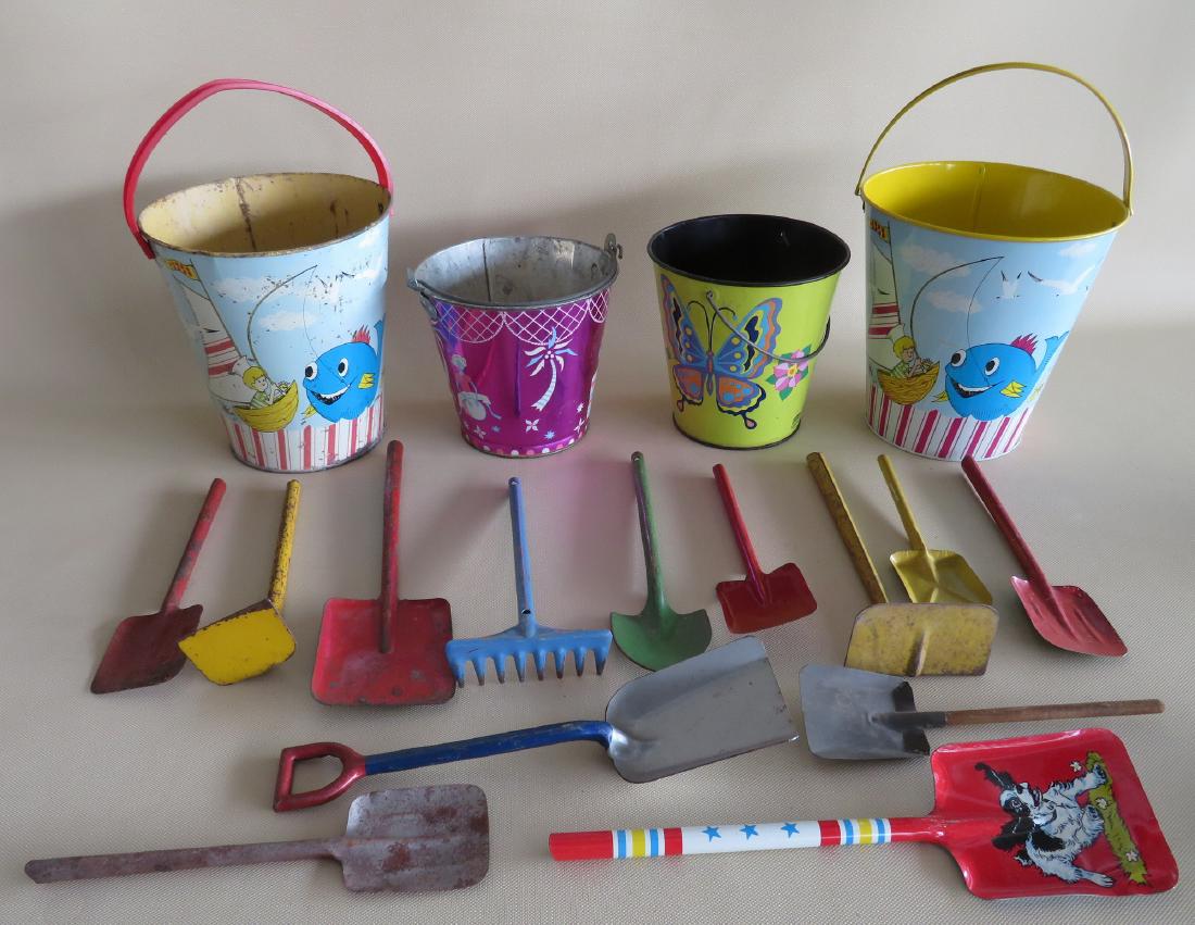 Four lithograph sand pails ranging in size from 6"H to: Four lithograph sand pails ranging in size from 6"H to 7 1/2"H, 9 sand shovels various sizes, 2 toy hoes, 1 toy garden rake, and 1 toy dirt shovel. All with some use wear, but overall good condition. 