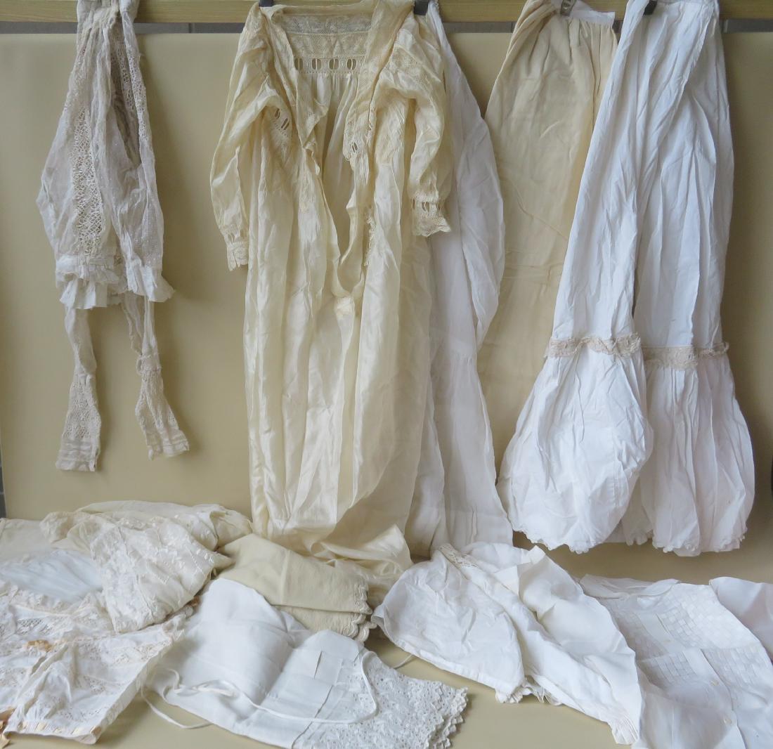 A grouping of 11 mostly lady's white undergarments,: A grouping of 11 mostly lady's white undergarments, late 19th to early 20th century. Some in lace and silk. Includes one lace blouse. Some may have minor stains, but overall they are in very good cond