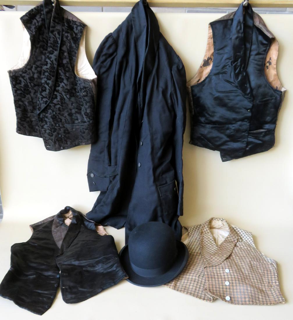 Grouping of gent's clothing including a black long: Grouping of gent's clothing including a black long jacket, a derby signed Emerson NY, and 4 vests (2 slightly soiled and 2 missing 1 button, else good condition).