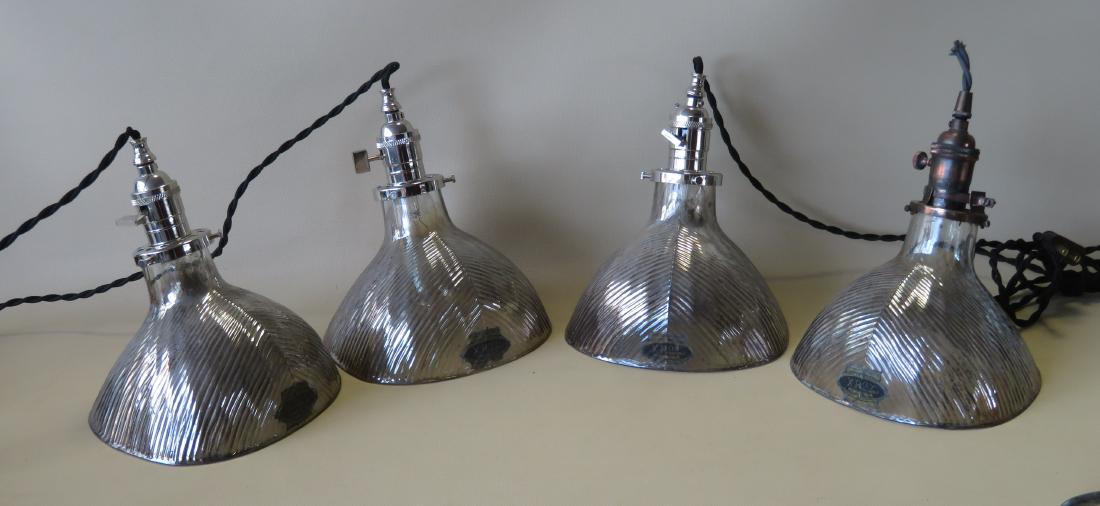 Four industrial ceiling fixtures with signed X-Ray No.: Four industrial ceiling fixtures with signed X-Ray No. 778 "Scoop" glass shades. The shades with silver exteriors with slight wear - typical surface wear on the edge of each shade, otherwise all are i