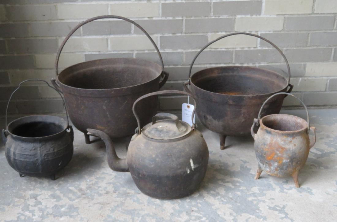 A grouping of 4 cast iron footed pots/cauldrons with: A grouping of 4 cast iron footed pots/cauldrons with bale handles, together with a cast iron goose neck tea kettle with a tin lid that appears to be original. The largest pot 11 1/4"H x 17 1/4"D. All 