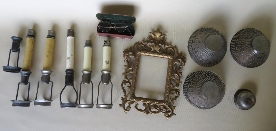 Grouping of decorative objects including gold filled: Grouping of decorative objects including gold filled eye glasses, counter bell, ornate brass frame, and 3 complete candle holder inserts with silver plated reticulated shades patent 1892. All items in