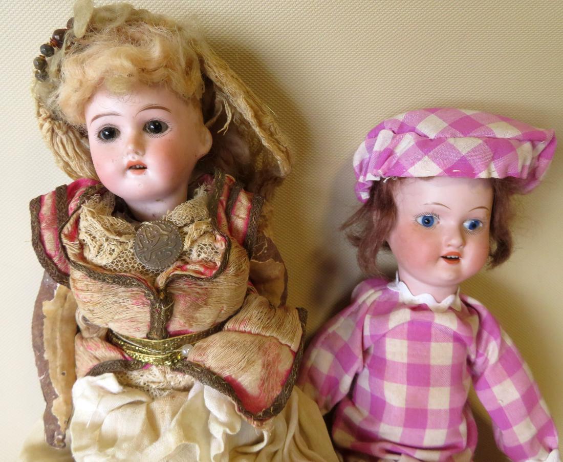 Two German dolls including: 1) Armand Marseille bisque: Two German dolls including: 1) Armand Marseille bisque head doll having fixed blue eyes and composition body -10"H - Marked "390 6/0 M" - Replaced costume, otherwise very good condition; 2) German dol