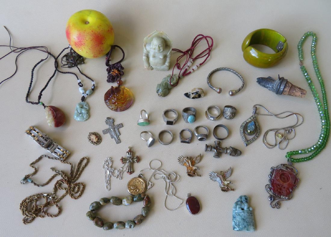 Grouping of silver and costume jewelry including:: Grouping of silver and costume jewelry including: Butterscotch Bakolite folding bracelet, green glass beaded necklace holding an oriental soapstone pendant, miniature soapstone figure of Buddha (chip 
