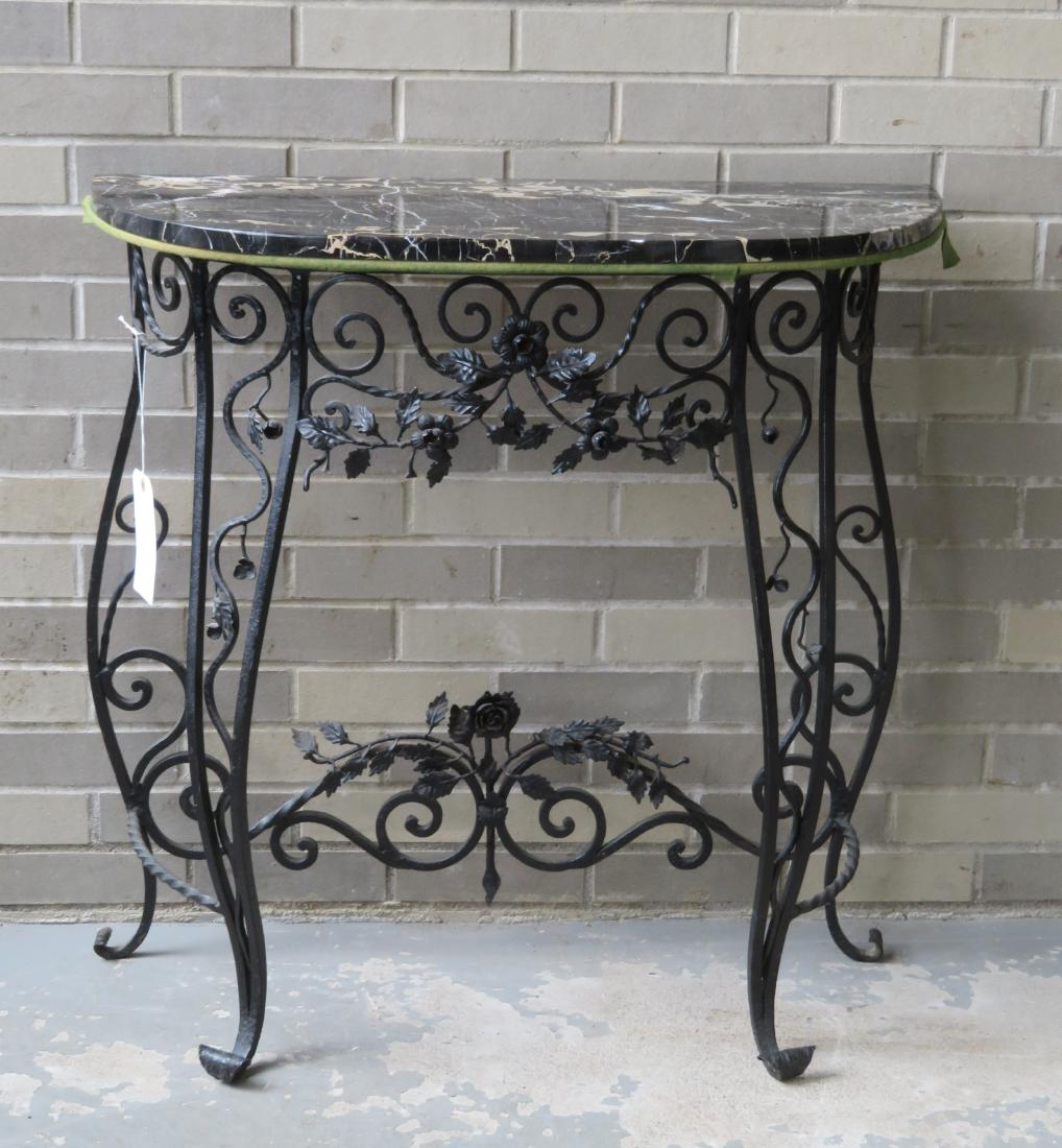 Fancy wrought iron demilune table with a black marble: Fancy wrought iron demilune table with a black marble top, and profusely decorated with colorful flowers. Sold with matching mirror with similar decorations. Table 31 1/2"W x 13 1/4"D x 31 3/4"H. Both