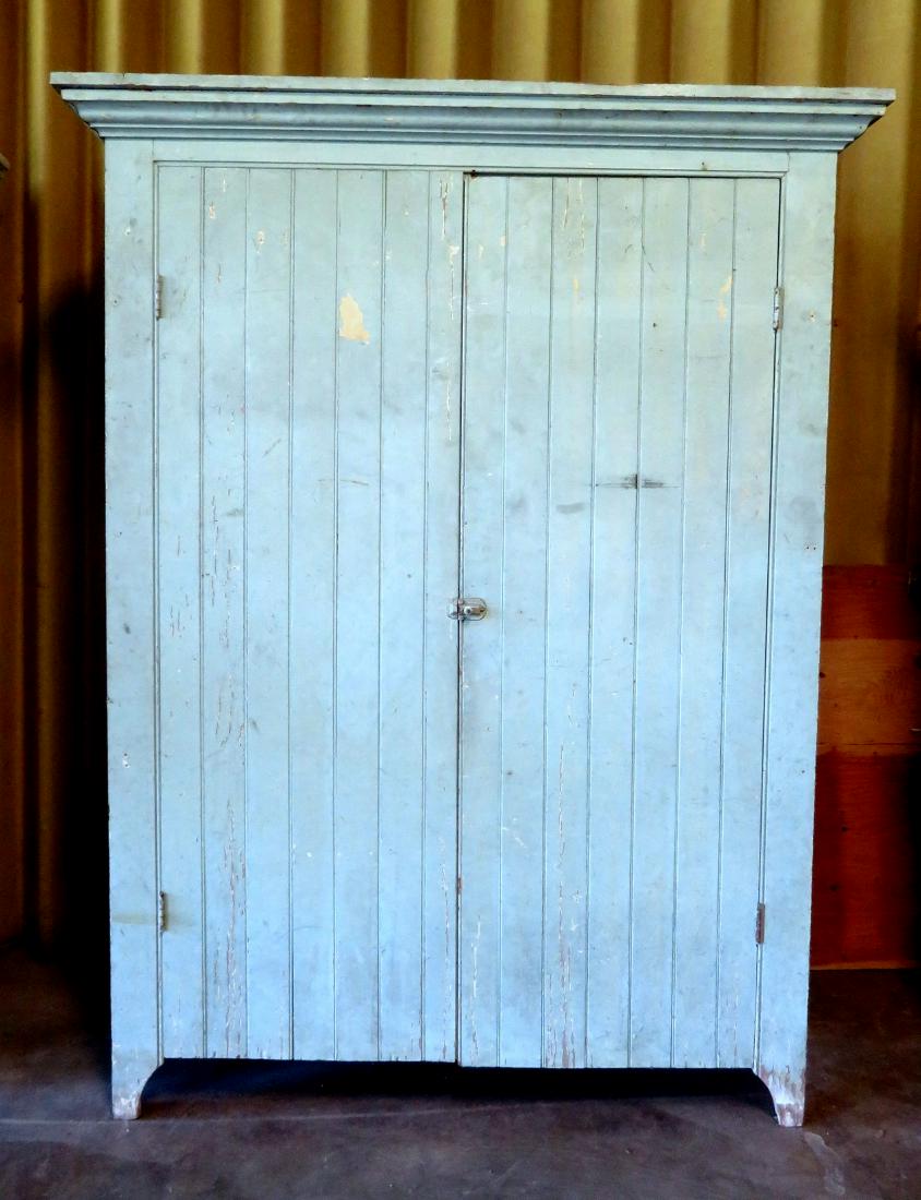 A large wainscot 2 door pantry cupboard with good: A large wainscot 2 door pantry cupboard with good cornice and cutout base, old green paint over several layers of paint, circa 1890. Minor use wear, and overall very good structural condition. 59 1/2"
