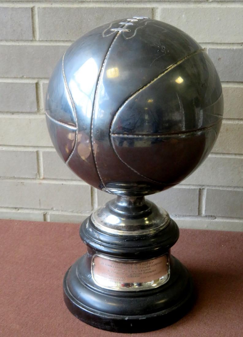 A Connecticut silver figural basketball trophy: A Connecticut silver figural basketball trophy depicting a large silver basketball mounted on turned wooden plinth in black paint, with silver plaque applied across the front and engraved "President's