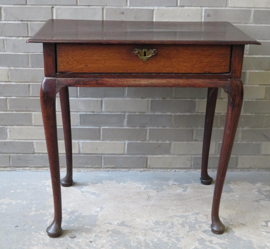 Queen Ann period single drawer work table with pad feet: Queen Ann period single drawer work table with pad feet and the top with molded edge. Original polished brass pull. Probably English, 18th century. The front drawer has been cleaned, the remainder of