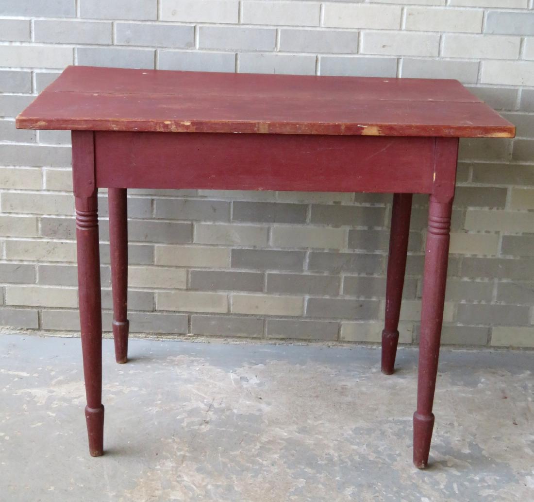 A good kitchen work table with turned legs, 2 board: A good kitchen work table with turned legs, 2 board top, in old red paint. Probably 1850-60. Size 39 1/8"W x 23 1/4"D x 31"H. Can be used as a work table or a small farm table that would seat 4.