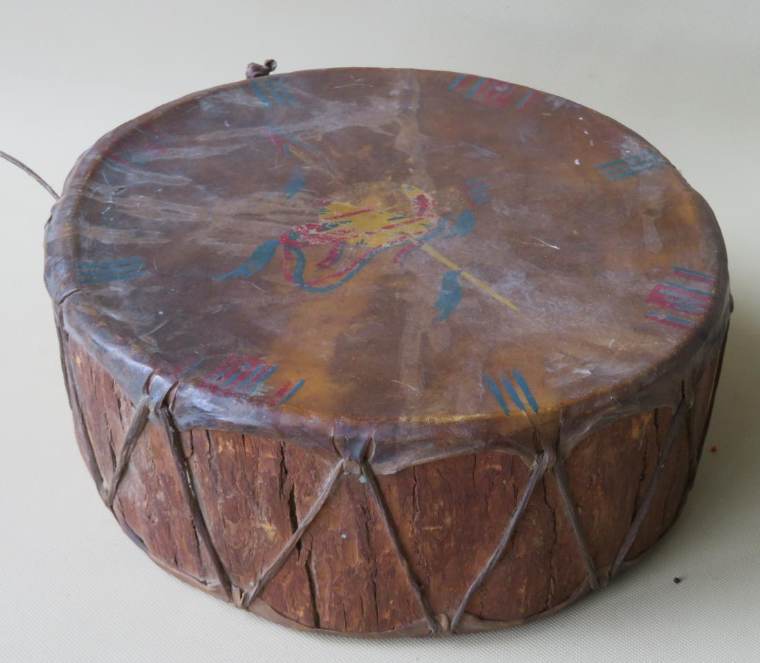 A Native American drum with bark sides and animal gut: A Native American drum with bark sides and animal gut top and bottom laced together with rawhide - the animal gut is hand painted in polychrome on both sides with spear and shield and the opposite sid