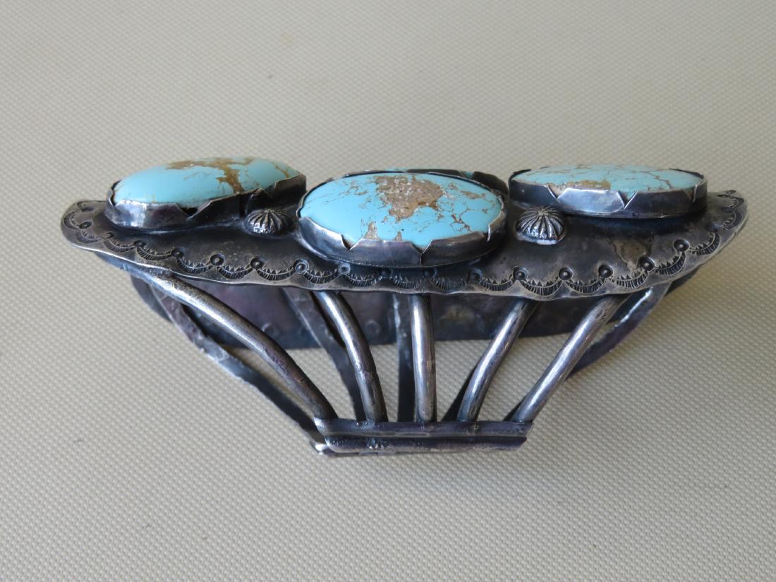 Large sterling silver Native American made bracelet: Large sterling silver Native American made bracelet with 7 large turquoise stones - total size 5 1/2L x 3 1/2"W x 2 1/2"H. Very good condition. Late 19th to early 20th century.