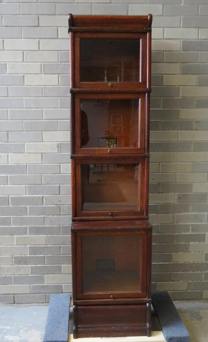 Small size Globe-Wernicke 4 section stacking bookcase.: Rare small size Globe-Wernicke 4 section oak stacking bookcase. The top 3 sections are set back over a larger base. The lower section labeled "E 13 1/2 Comb. / 299" - one of the 3 upper sections label