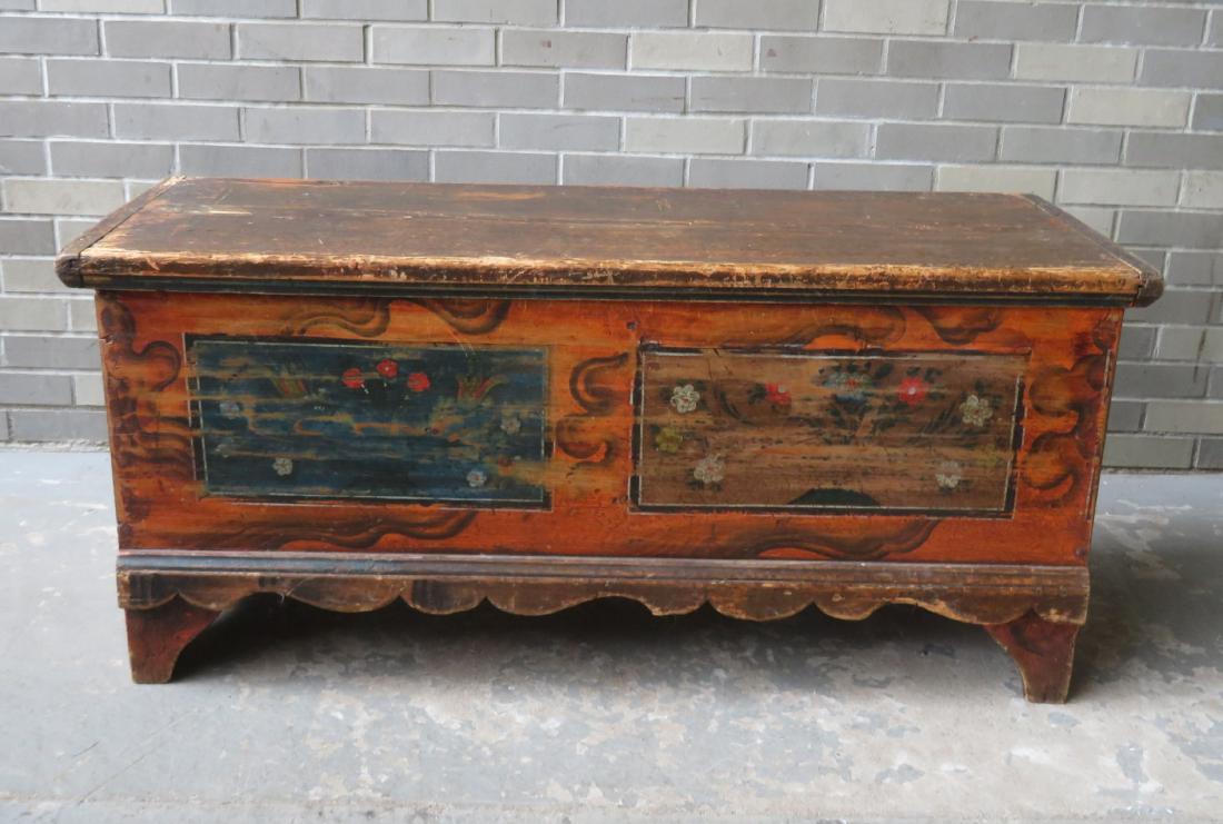 Primitive grain painted and decorated blanket box with: Primitive grain painted and decorated blanket box with hand forged iron hinges, and having 2 rectangular panels across the front that are decorated with hand painted flowers in basket design, and also