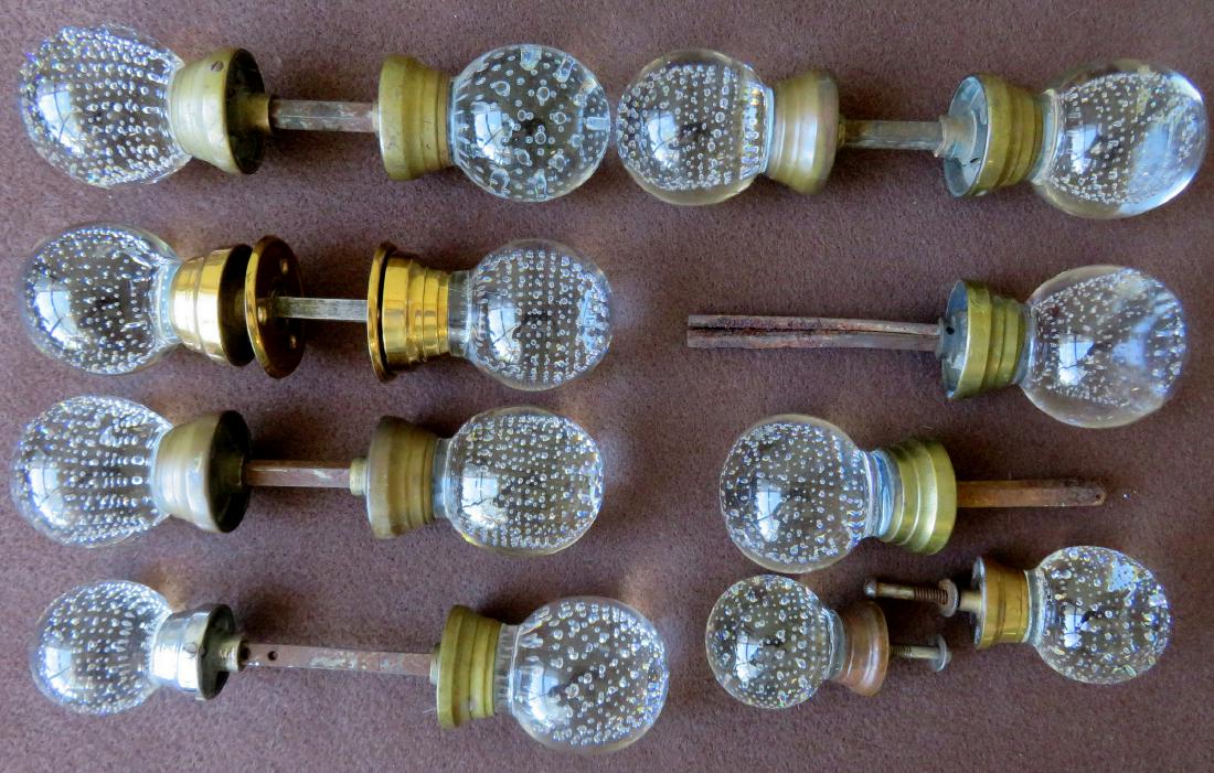 A grouping of 7 sets of "controlled bubble" glass door: A grouping of 7 sets of "controlled bubble" glass door knobs, attributed to Pairpoint. Includes 5 matching pairs. Probably late 19th century. Average diameter 2 1/2". Most missing the back plates, sev