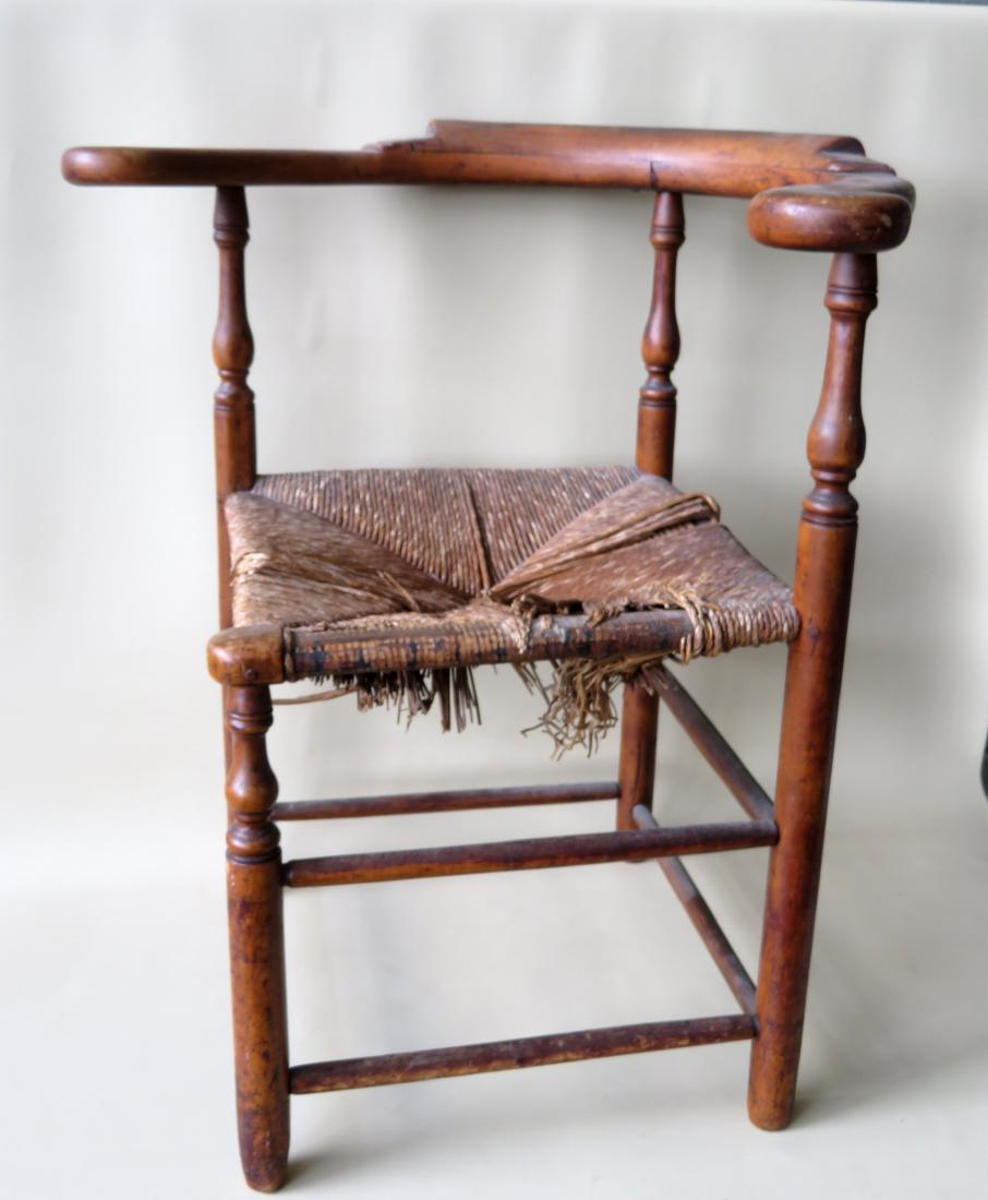 Queen Anne maple corner chair with shaped arms and with: Queen Anne maple corner chair with shaped arms and with remnants of a rush seat, late 18th century. Two small wood splits in the raised portion of the arm curved back rail, else good condition. 28 1/4
