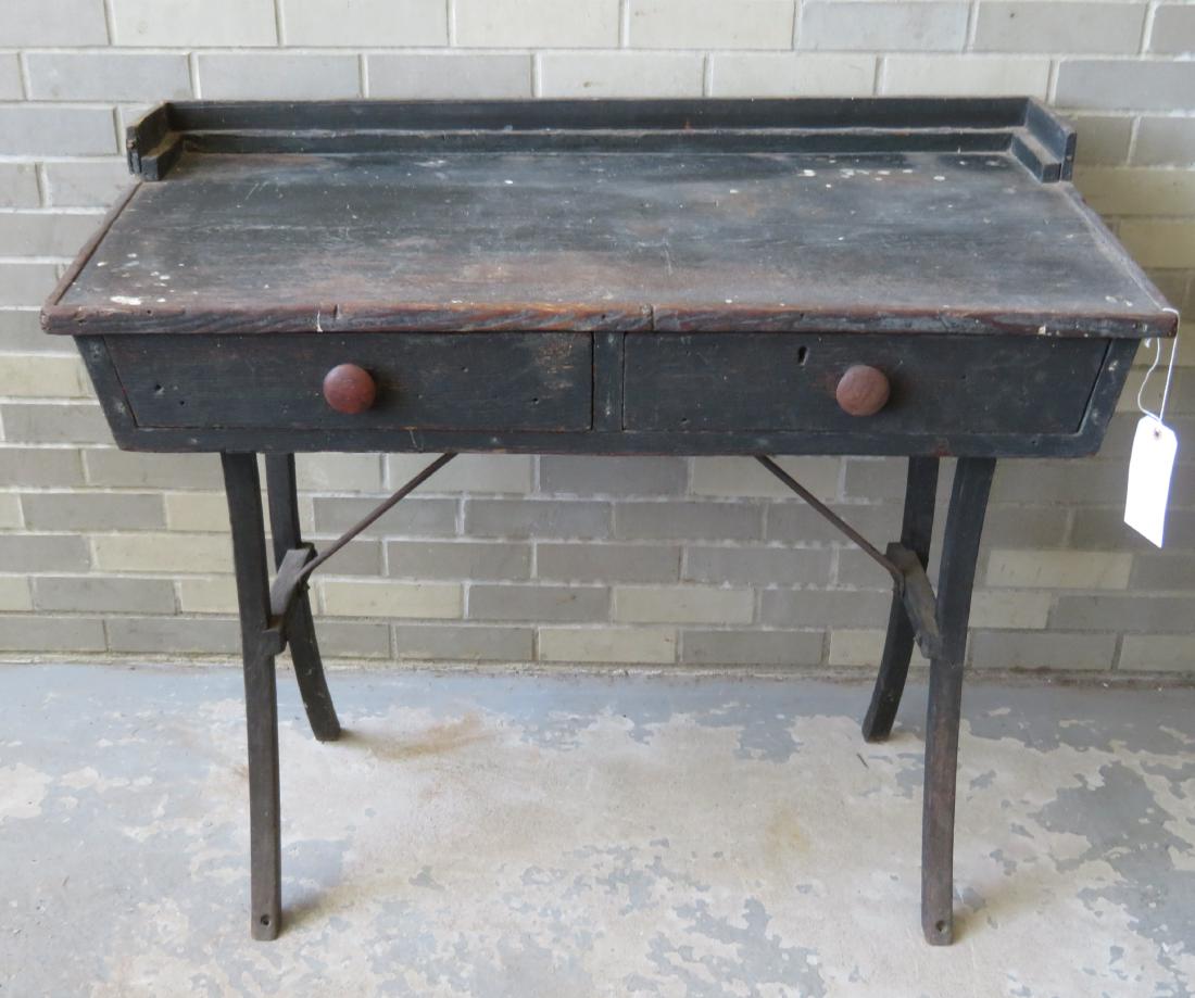 Primitive country store desk with slanted top over 2: Primitive country store desk with slanted top over 2 drawers, in original black paint, constructed of oak and pine, late 19th century. Some use wear, but overall good condition. 41 3/4"W x 21 1/2"D x 