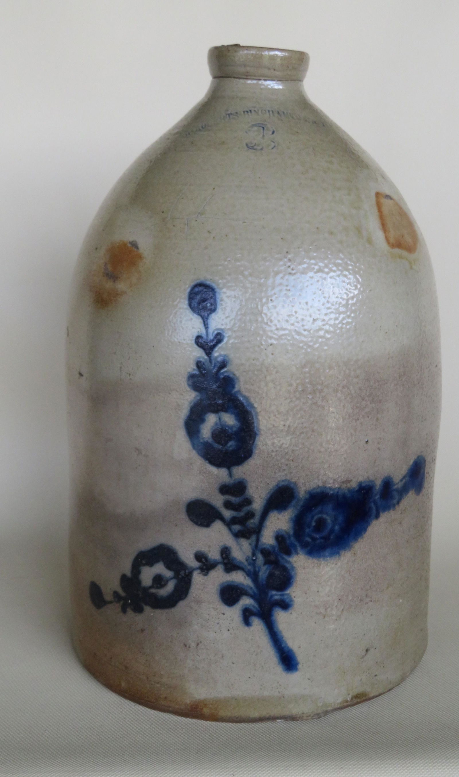 Stoneware 3 gallon jug decorated with a large cobalt: Stoneware 3 gallon jug decorated with a large cobalt blue flower with impressed mark "W. Roberts / Binghamton N.Y.". Staining along bottom, a chip along the bottom edge, and slight crazing top left si