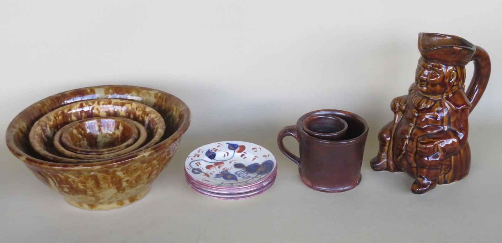 A grouping of country items including: A partial nested: A grouping of country items including: A partial nested set of 4 spongeware mixing bowls ranging in size from 4 1/4"D to 10 1/2"D - all very good condition - 19th century; an unusual redware cup with
