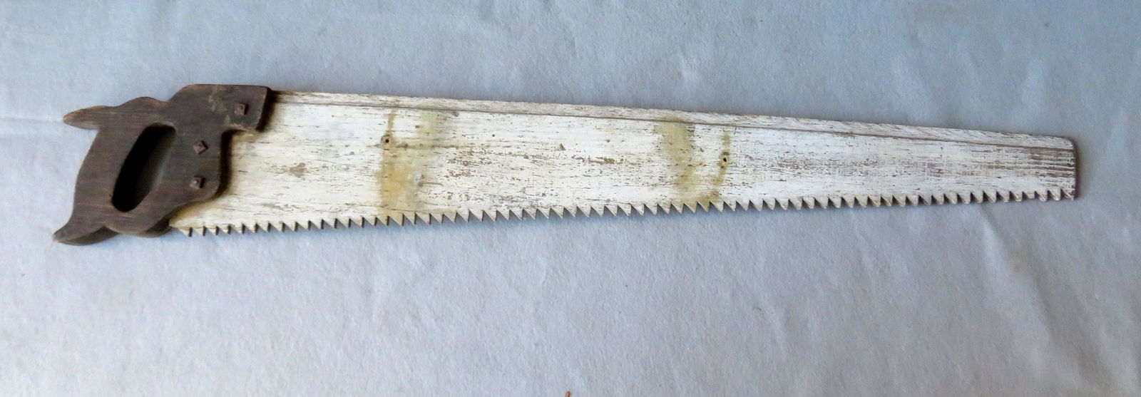 A Carpenter's trade store sign in the form of a wooden: A Carpenter's trade store sign in the form of a wooden saw in original paint, late 19th to early 20th century. 38 5/8"L. Slight wear to paint, otherwise very good condition.
