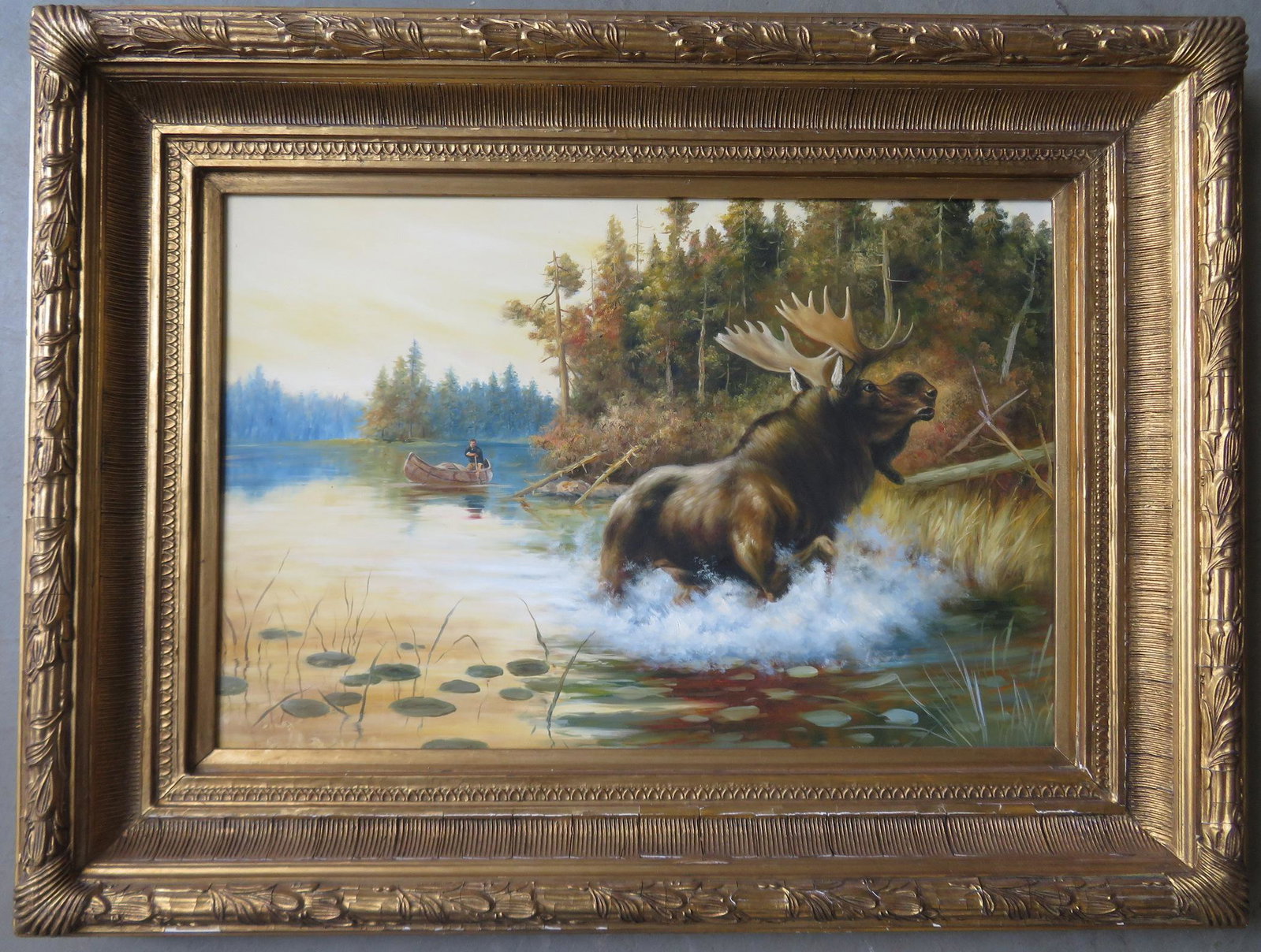 O/C Adirondack action landscape depicting a startled: O/C Adirondack action landscape depicting a startled moose in water with man paddling a birch bark canoe in the background - newer painting probably late 20th century, and in excellent condition as is