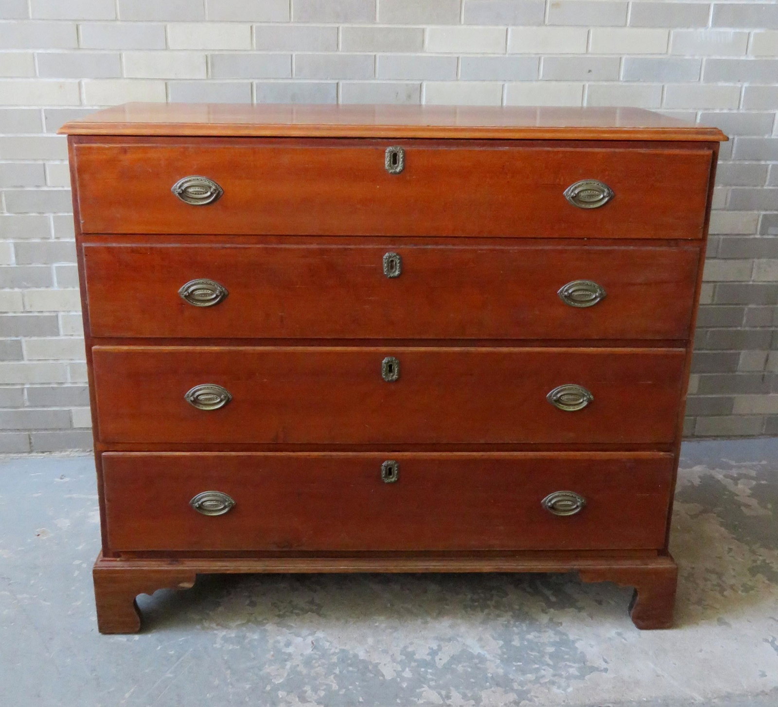 Early cherry Chippendale blanket chest having 2 false: Early cherry Chippendale blanket chest having 2 false drawers over 2 drawers on a bracket base - the lid with molded edge and original rattail hinges - note the interior till which is usually not pres