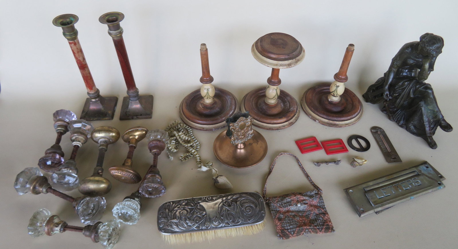 Grouping of decorative accessories including a beaded: Grouping of decorative accessories including a beaded purse, a grouping of vintage glass and brass door knobs, a hand painted hat holder, a fancy brass match holder with patent date 1900 etc.