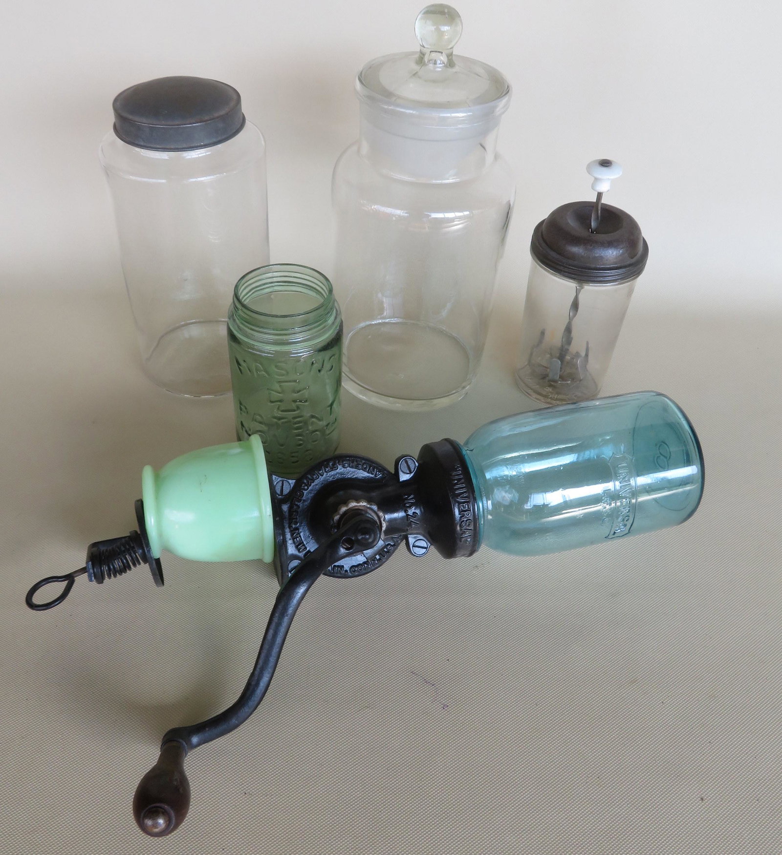 Grouping of country items including: An early glass jar: Grouping of country items including: An early glass jar with tin lid - 9 1/2"H; an apothecary glass jar with glass lid - 12"H; a McClean Black masher with original tin lid; a light green Mason jar dat